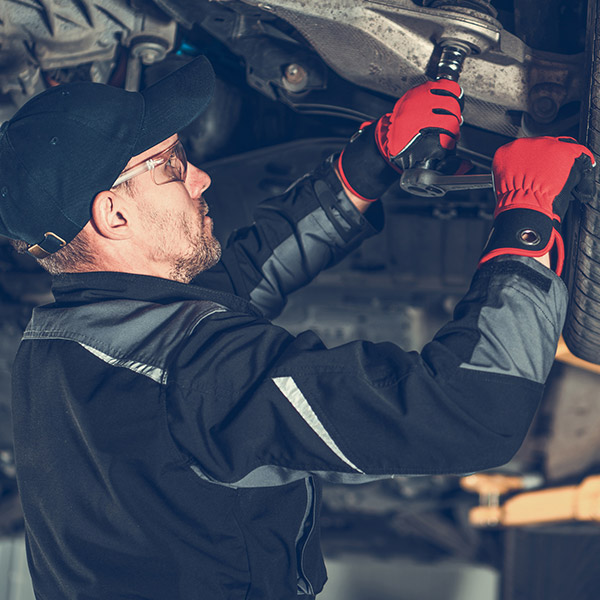 Automotive Mechanic Replacing Car Suspension Elements