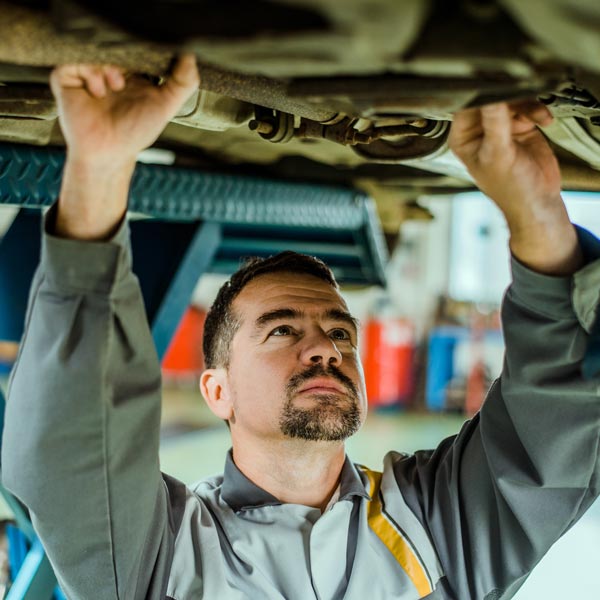 mechanic working under car